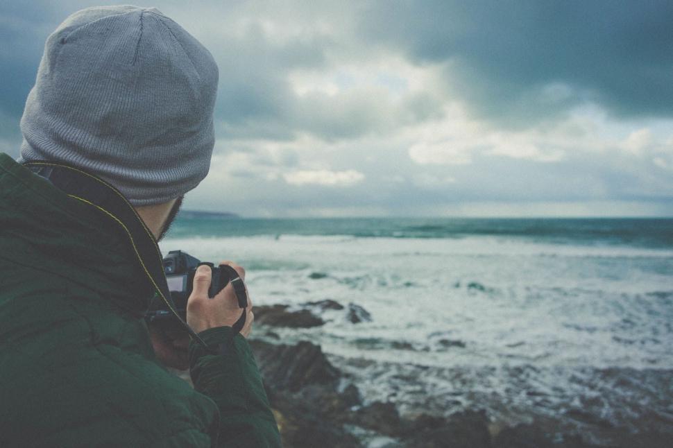 Free Image of Man Taking Picture of Body of Water 