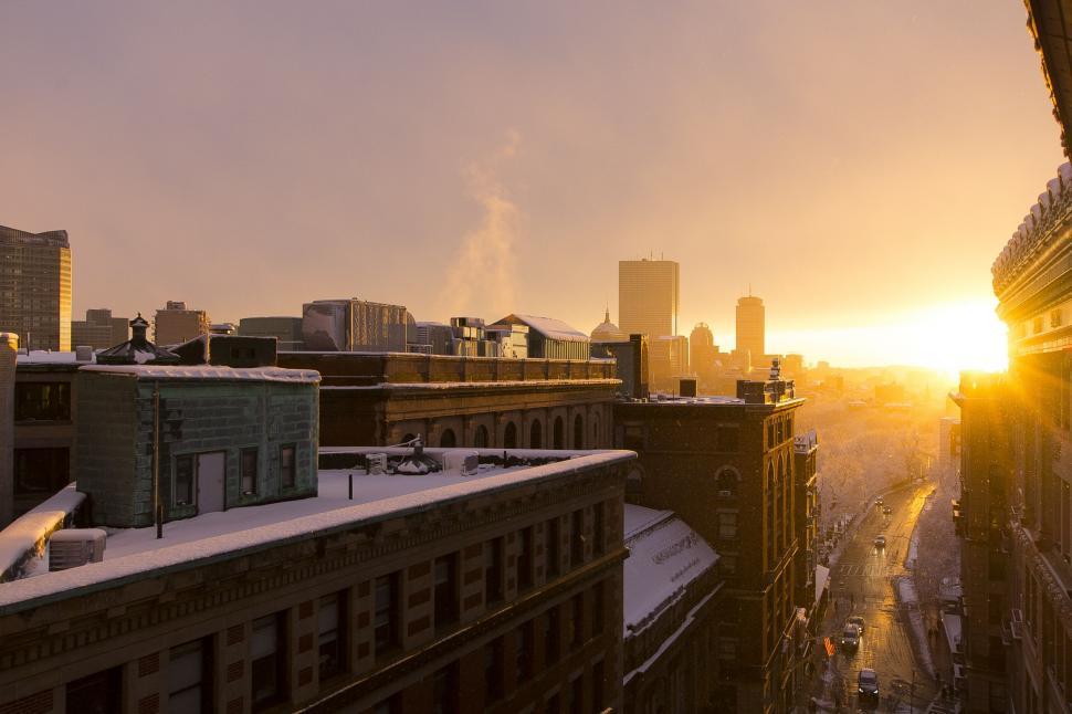 Free Image of The Sun Setting Over City Skyline 