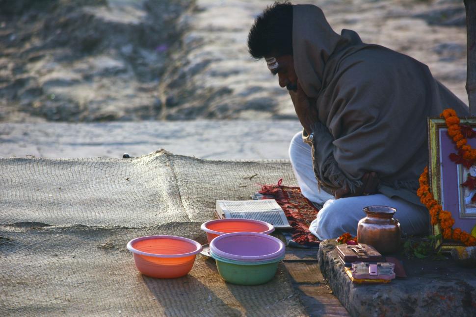 Free Image of Man Sitting Next to Bowls of Food 