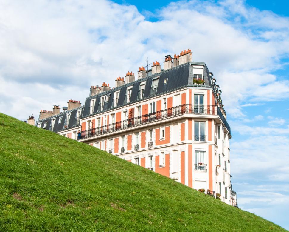 Free Image of Tall Building on Lush Green Hillside 