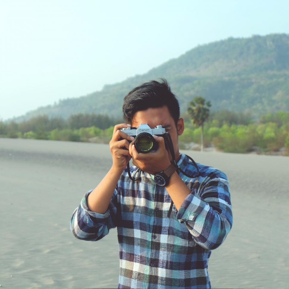 Free Image of Man Holding Camera Up to His Face 