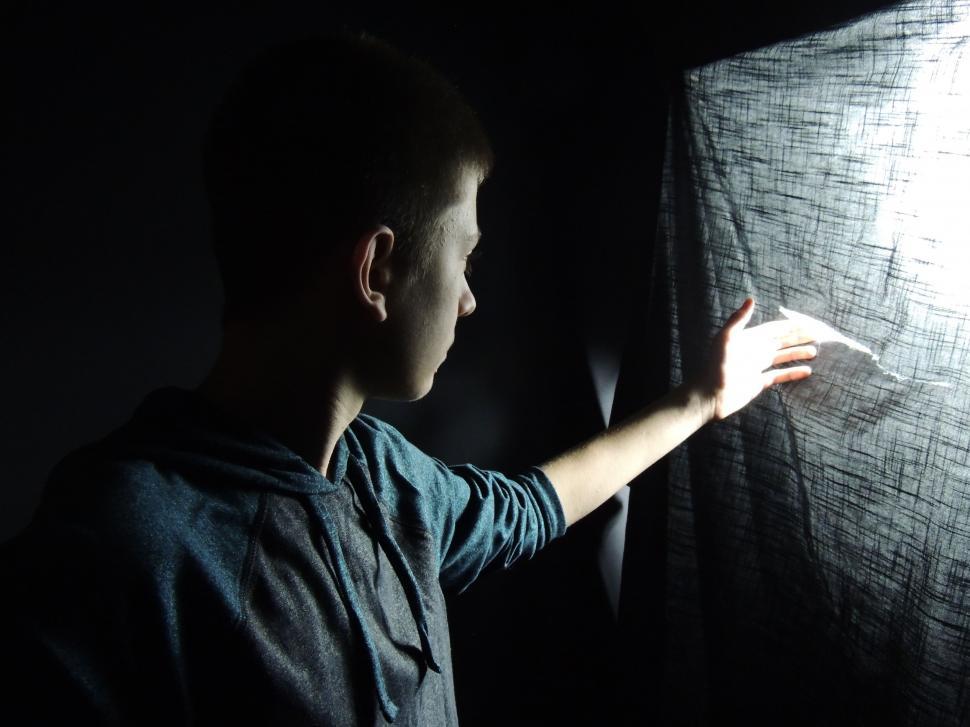 Free Image of Man Holding Light in Dark 