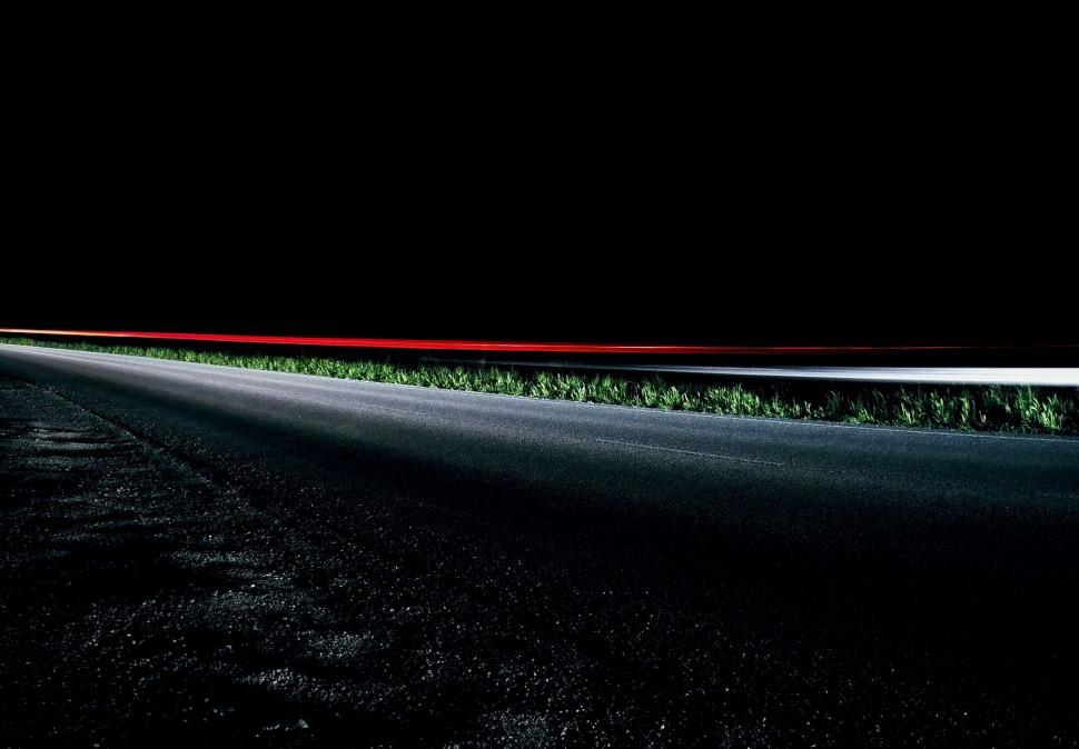 Free Image of Car Driving Down Dark Road at Night 