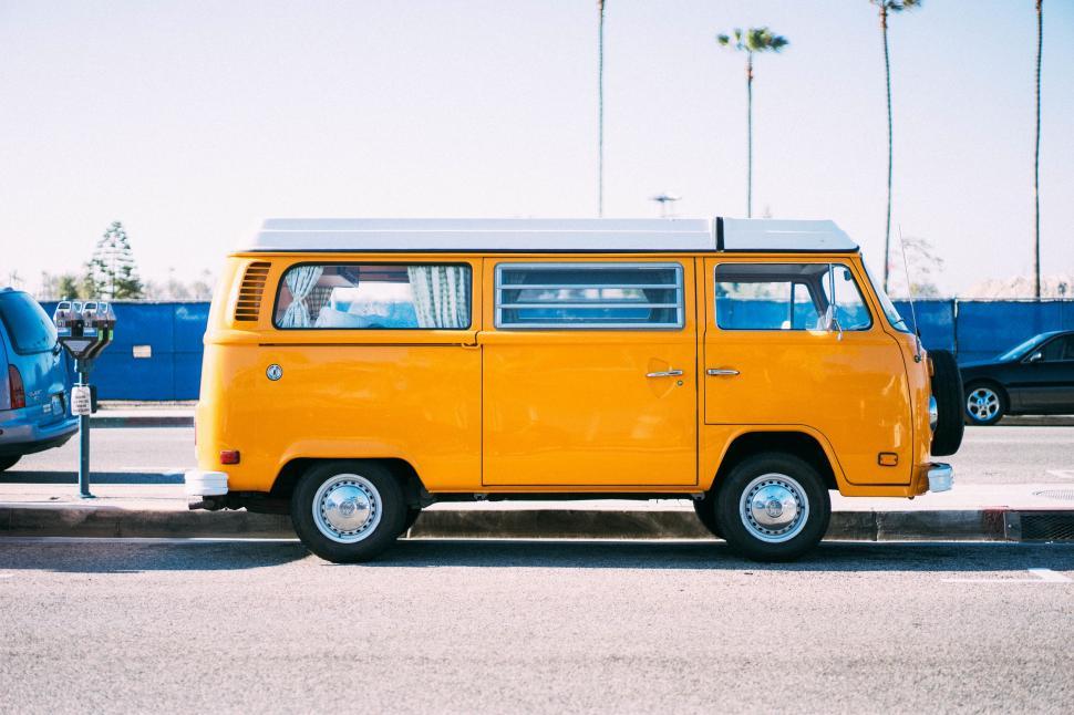 Free Image of Yellow Van Parked Next to Parking Meter 