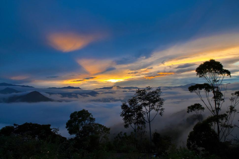 Free Image of Sun Setting Over Clouds in the Mountains 