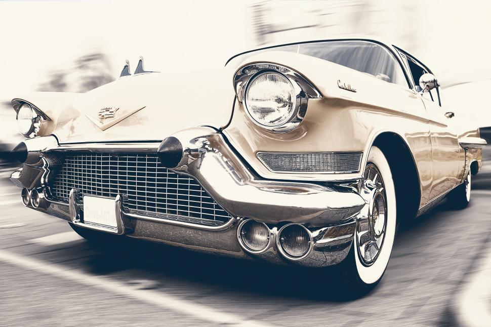 Free Image of Two Cars Driving Down City Street 