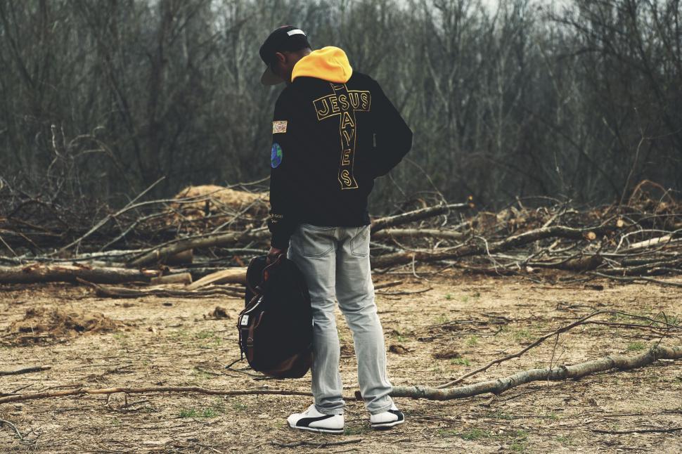 Free Image of Person Standing in Field With Backpack 