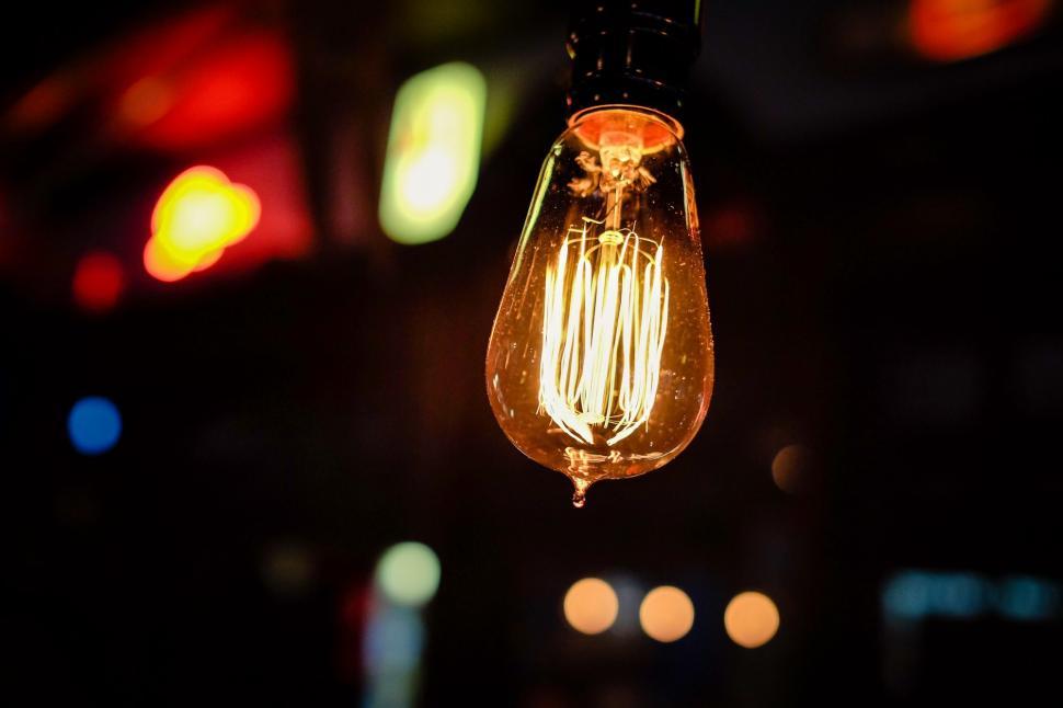 Free Image of Light Bulb Hanging in Dark Room 