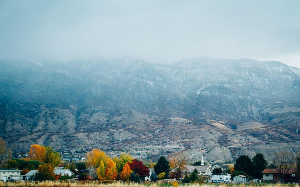 Free Image of Mountain Range and Houses in Foreground 
