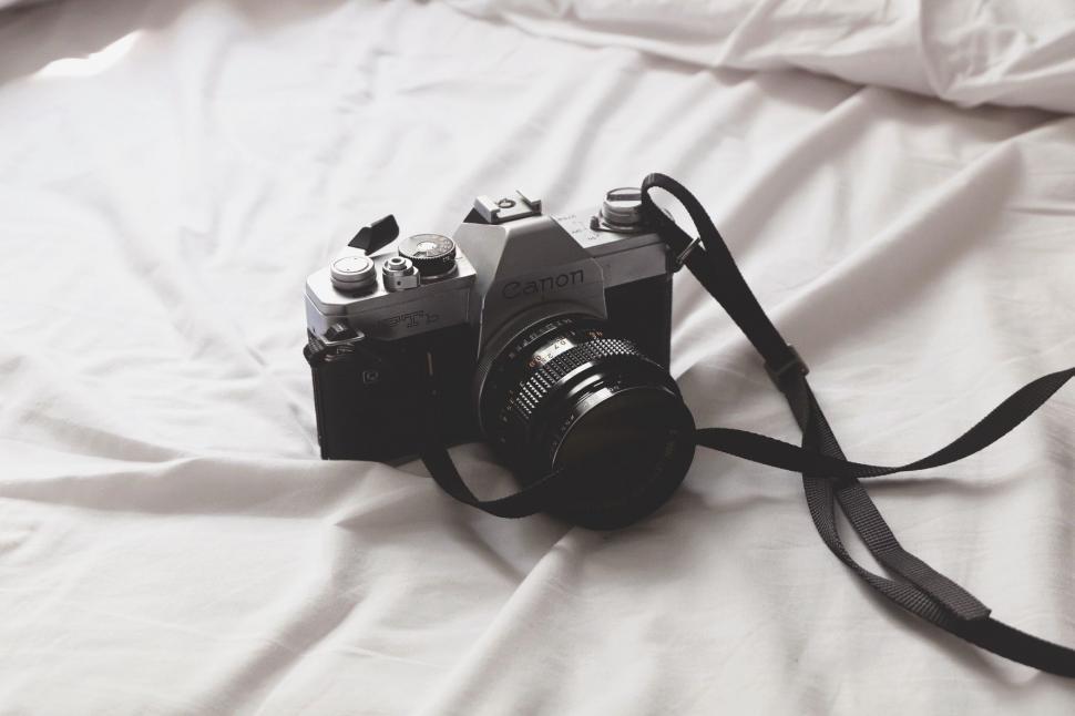 Free Image of Camera Resting on Bed 