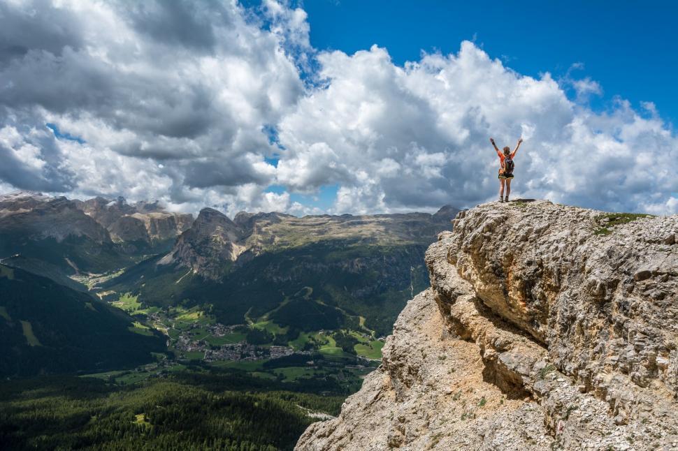 Free Image of Person Standing on Top of Large Rock 