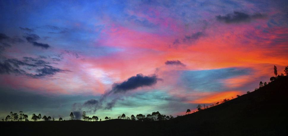 Free Image of Colorful Sky With Clouds and Trees 