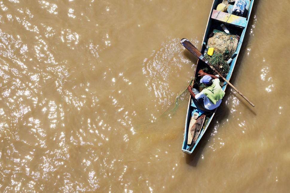 Free Image of Man Riding Boat Down River 