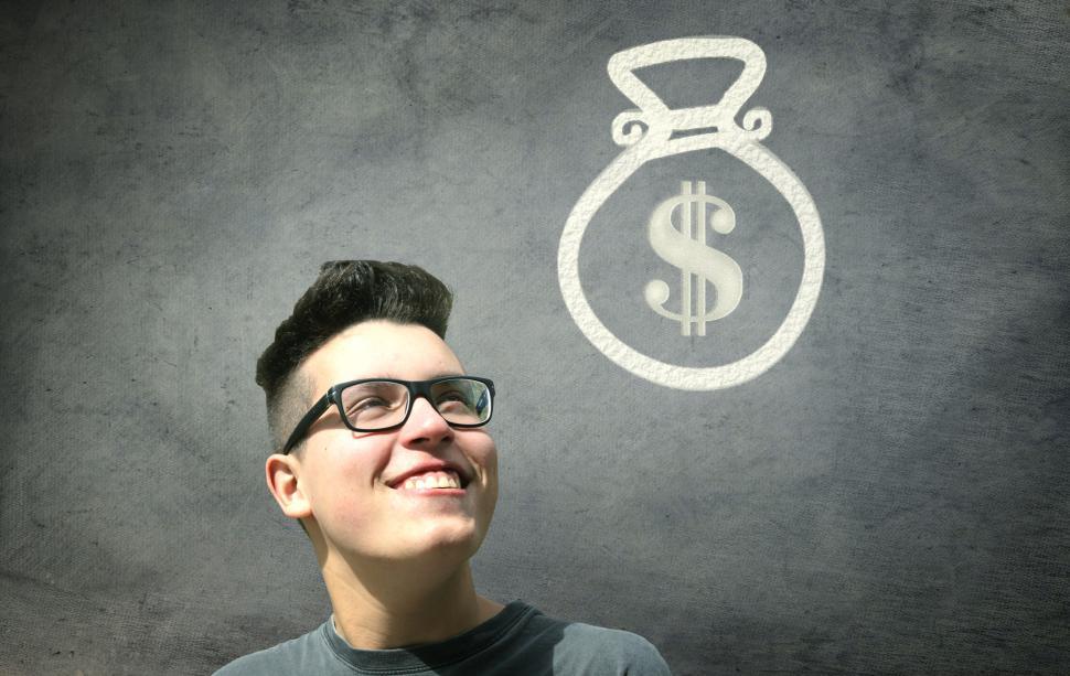 Free Image of Prize Winner - Young Man Smiling with Bag of Money 