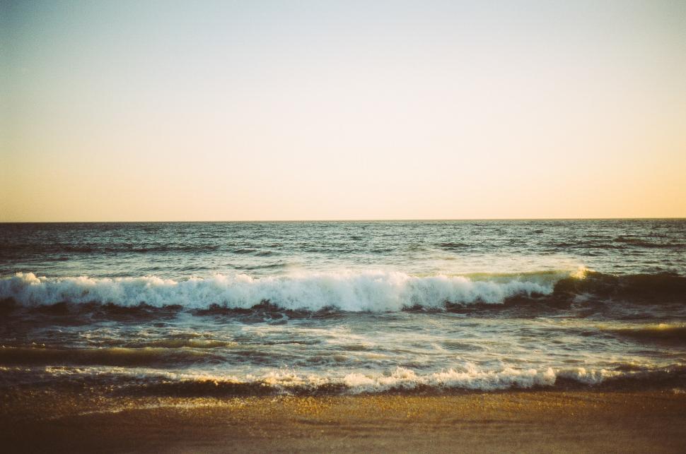 Free Image of Waves Rolling Onto Sandy Beach 