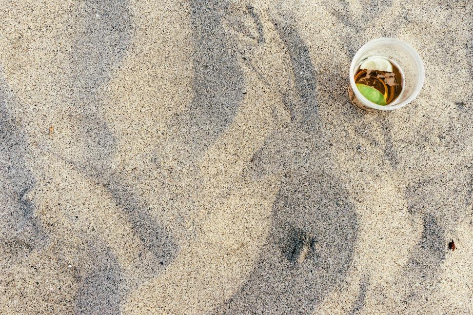 Free Image of A Cup of Coffee on Sandy Beach 