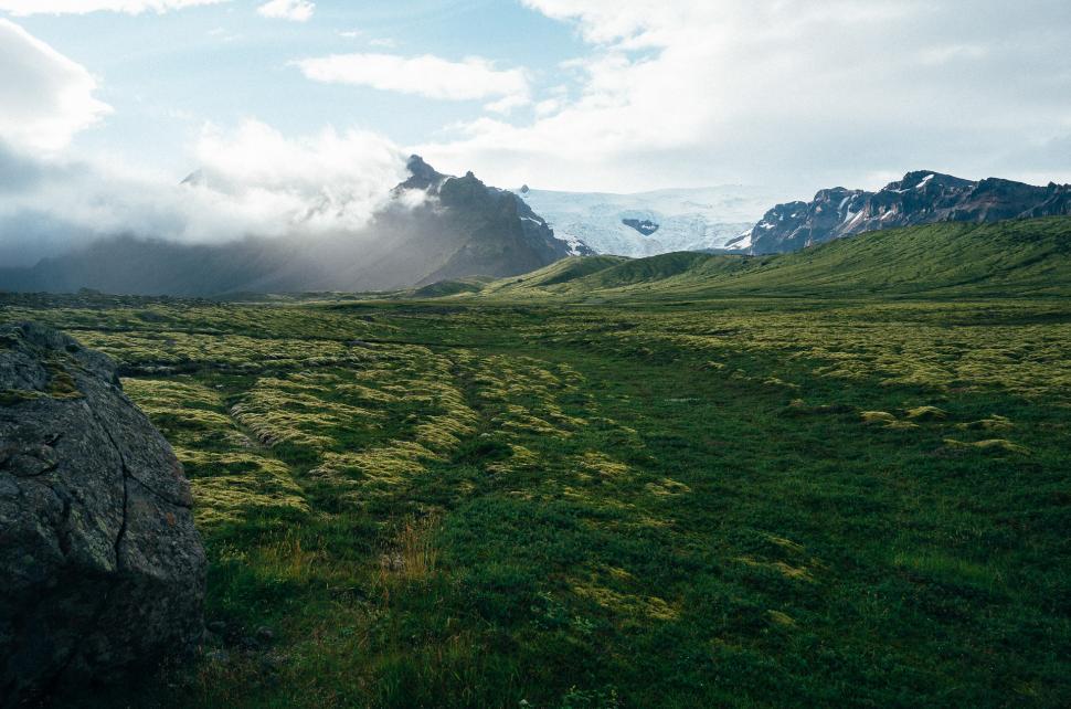 Free Image of Grassy Field With Mountains in the Background 