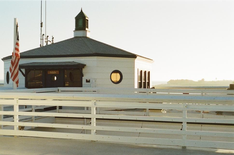 Free Image of Small White Building With Flag 