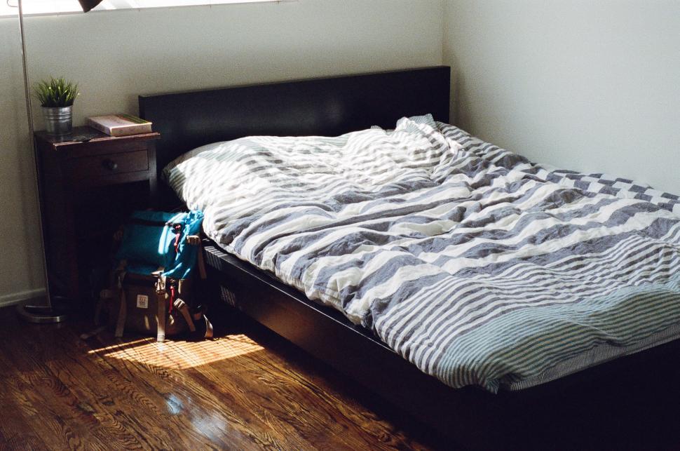 Free Image of Bed Sitting Next to Window in Bedroom 