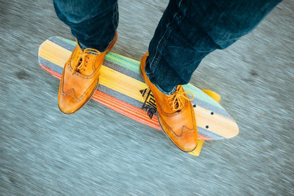 Free Image of Person Standing on Top of a Skateboard 