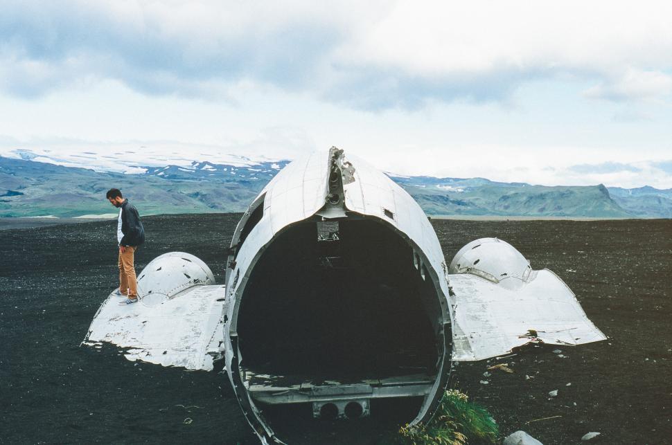 Free Image of Man Standing Next to Plane on Field 