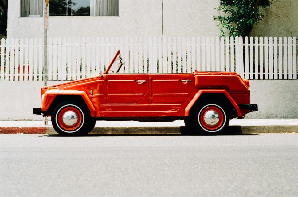 Free Image of Red Jeep Parked on Side of Road 