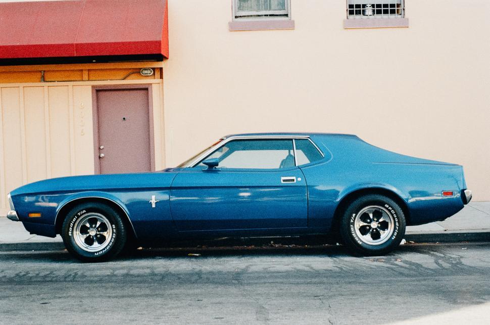 Free Image of Blue Car Parked in Front of Building 