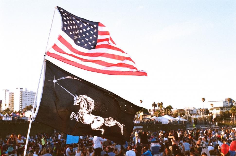 Free Image of Crowd of People Standing Around a Flag 