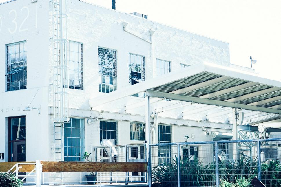 Free Image of White Building With Wooden Bench 