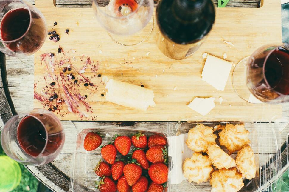 Free Image of Wooden Table Set With Glasses of Wine and Food 