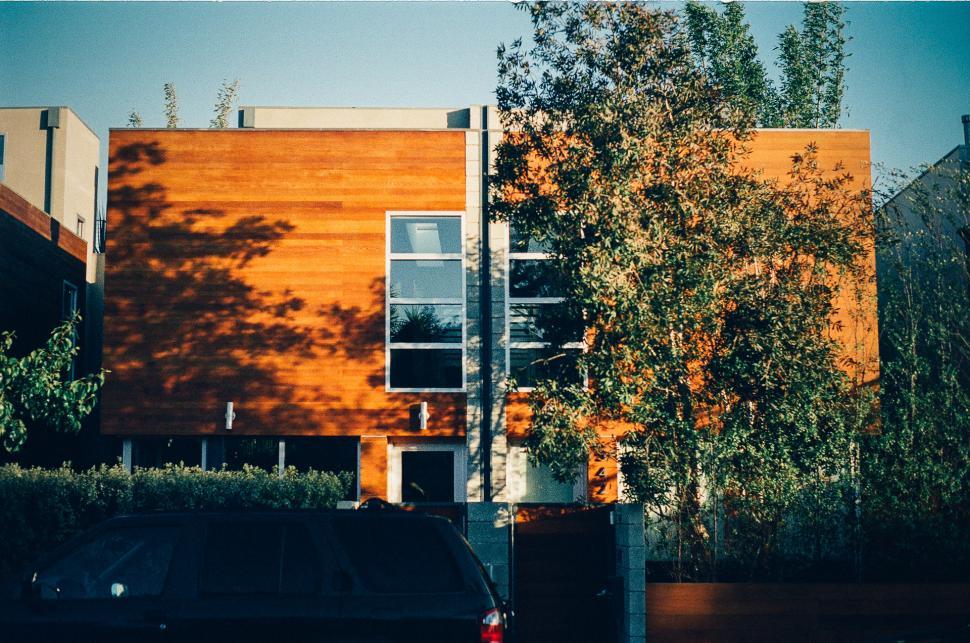 Free Image of Car Parked in Front of Tall Building 