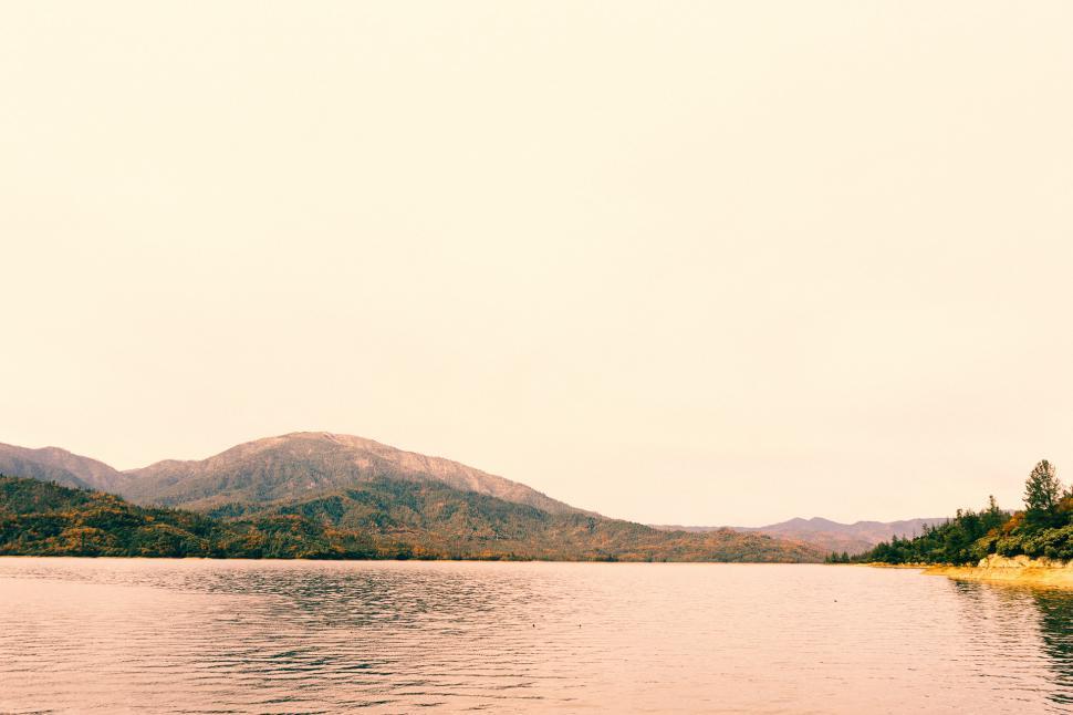 Free Image of Majestic Mountains Towering Over a Pristine Lake 