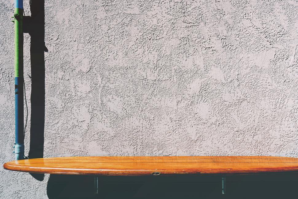 Free Image of Wooden Surfboard on Wooden Shelf 