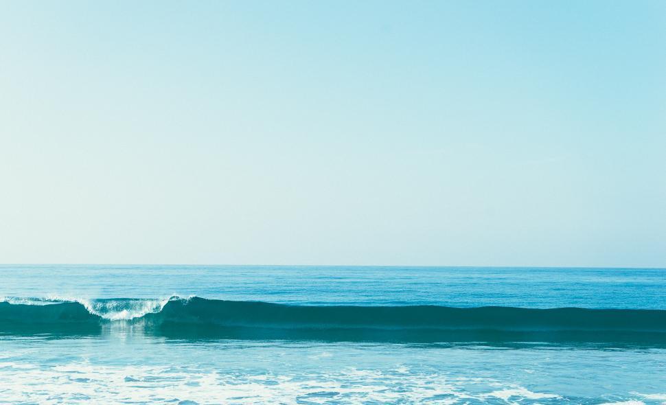 Free Image of Man Riding Wave on Surfboard 