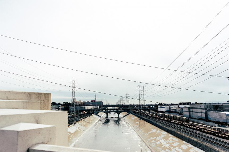 Free Image of Train Traveling Along River Tracks 