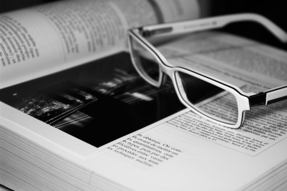 Free Image of Glasses Resting on Book 