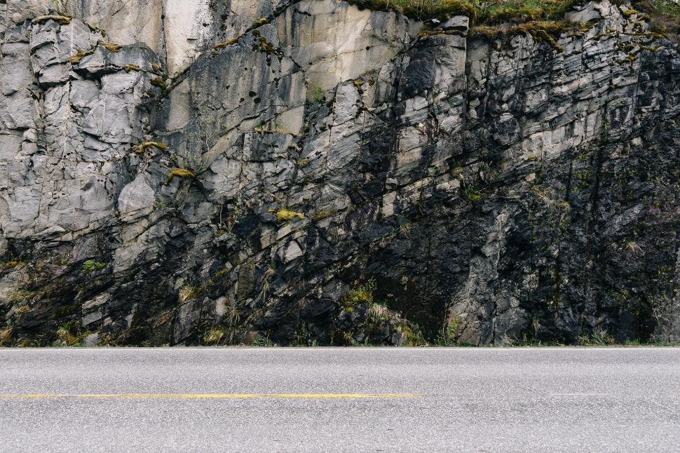 Free Image of Man Skateboarding Down Side of Road 
