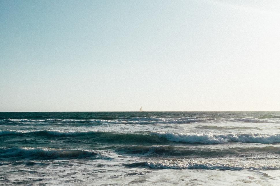Free Image of Person Riding Surfboard on Top of Ocean Wave 