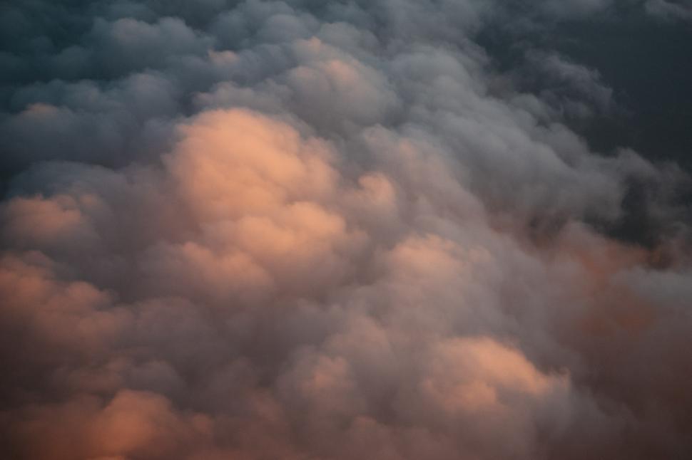 Free Image of Plane Flying Through Cloudy Blue Sky 