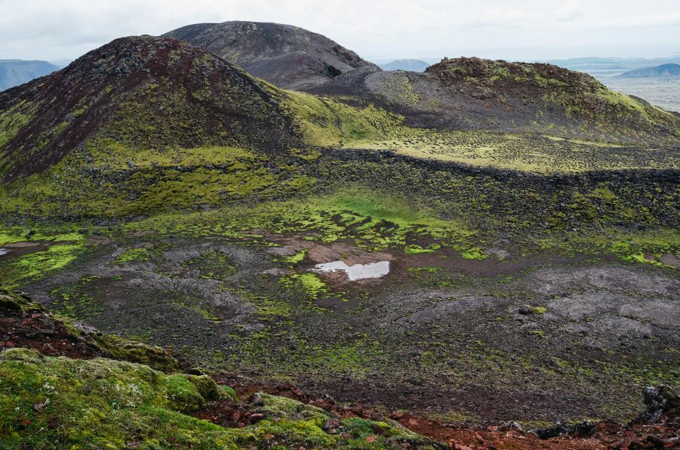 Free Image of Lush Green Grass and Dirt Covered Mountain 