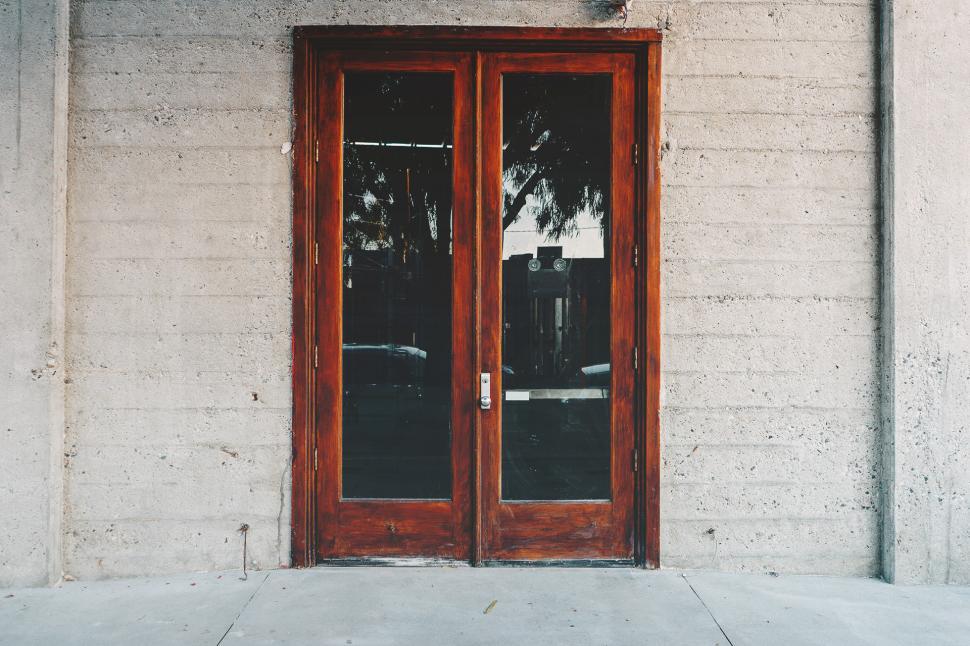 Free Image of Red Door Leaning Against Building 