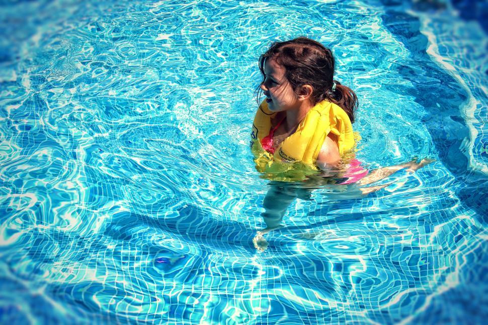 Free Image of Little Girl Learning To Swim with Life Vest 