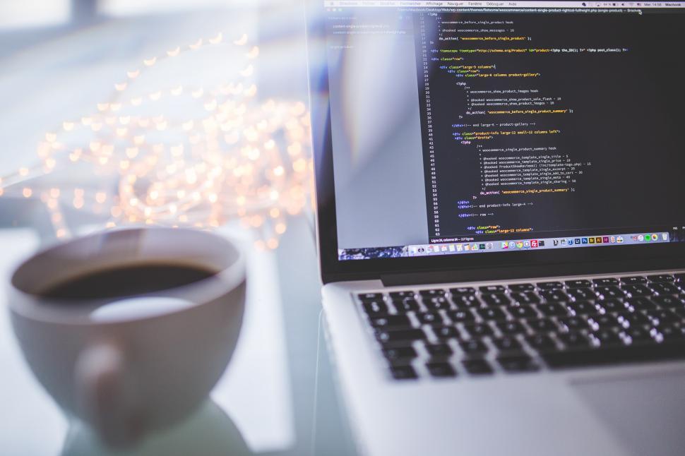 Free Image of Laptop Computer on Desk Next to Coffee Cup 