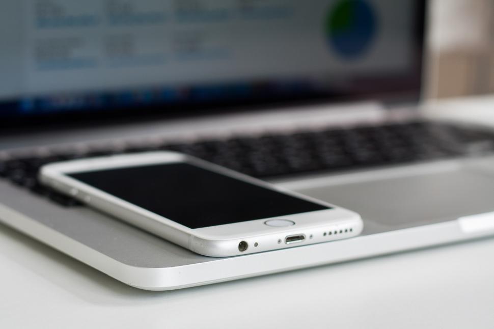 Free Image of Cell Phone on Top of Laptop Computer 