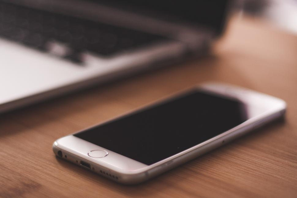 Free Image of Cell Phone on Wooden Table 