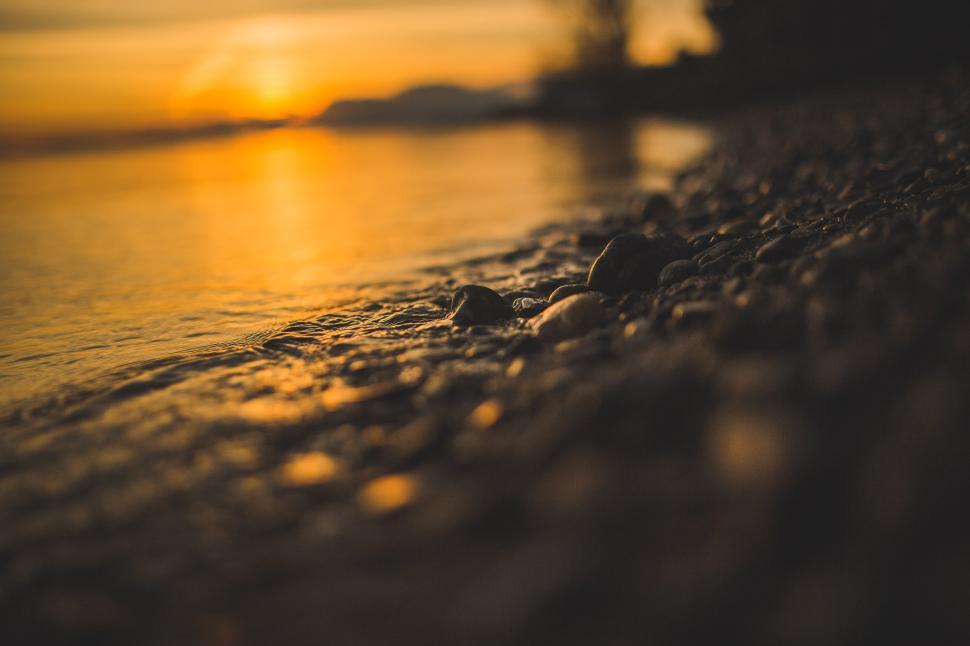 Free Image of Sun Setting Over a Beach 