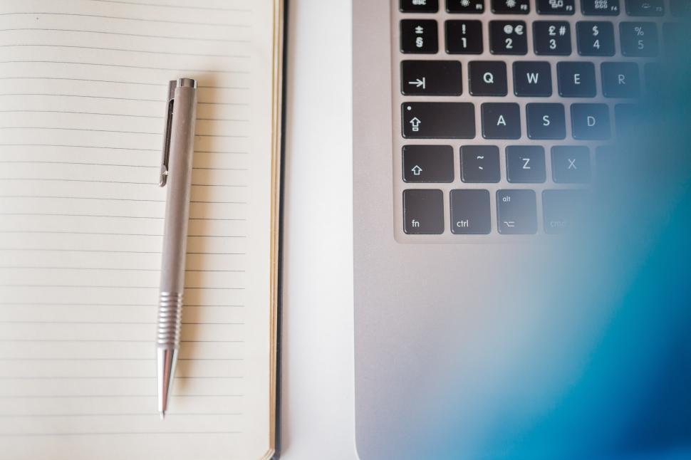 Free Image of Notebook and Pen on Laptop 