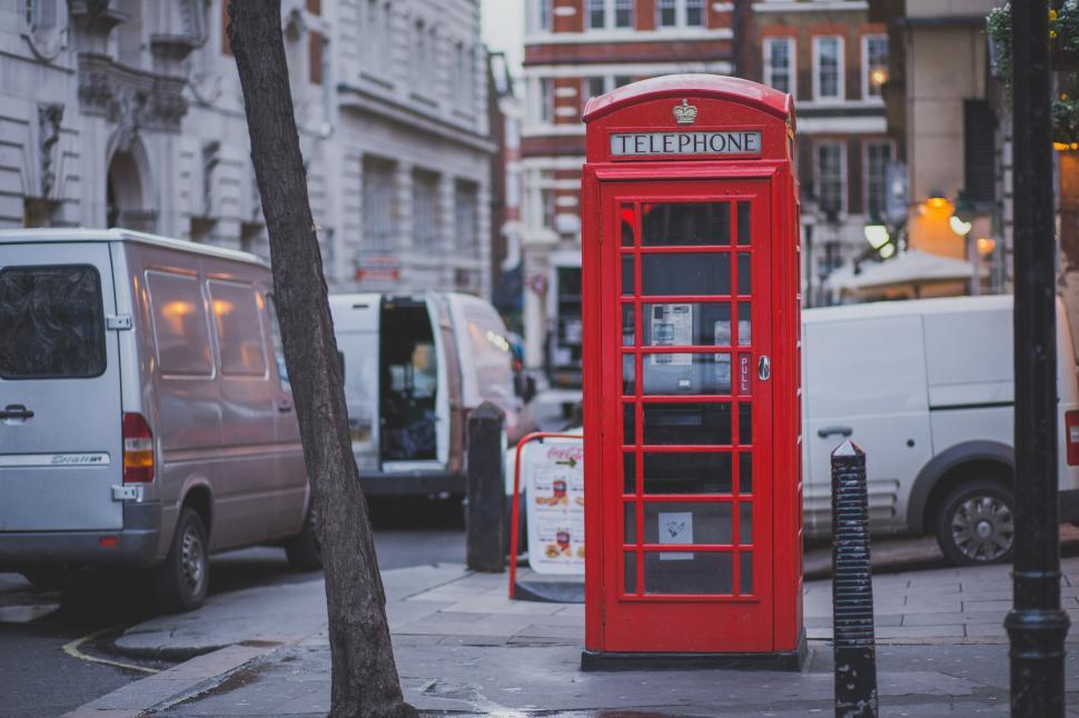 Free Image of Red Phone Booth by the Side of the Road 