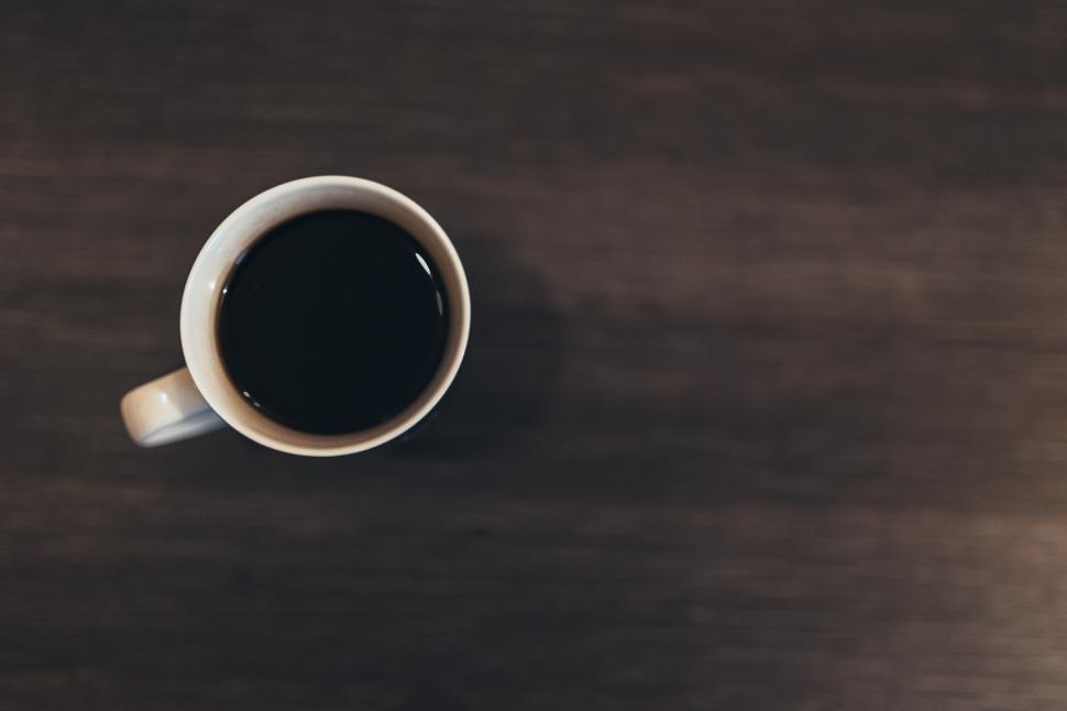 Free Image of A Cup of Coffee on Wooden Table 