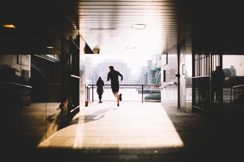 Free Image of Man and Child Walking Down a Hallway 